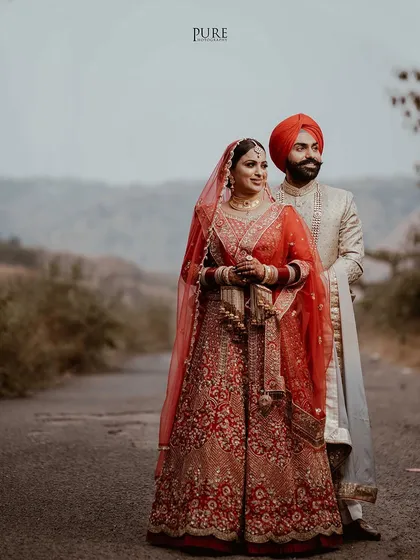 A stunning wide-angle portrait of the couple on an open road, symbolizing the beginning of their journey together.