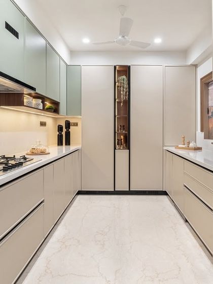 This sleek, modular kitchen is designed for ultimate functionality. The parallel counters provide ample workspace, while the subtle two-tone cabinets and integrated appliances create a clean, modern aesthetic.