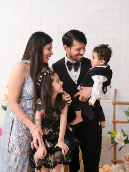 A candid moment of connection during a formal family shoot. The family shares a look of love, showcasing the real emotion behind the portrait.