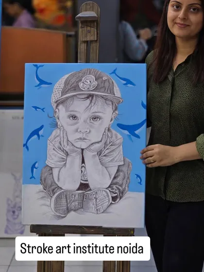 A finished portrait that tells a story. This student proudly presents her ballpoint pen artwork of a young child, where the detailed black and white drawing is set against a vibrant blue background.