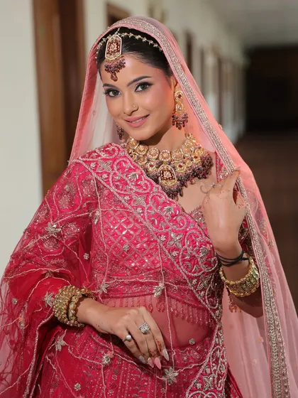 Soft, natural, and radiant. This bridal glam is perfect for the modern bride who wants to look timeless. The makeup enhances her features while the soft pink tones of the lehenga add a romantic touch.