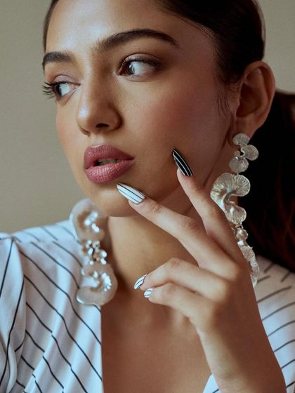 A close-up of the striped nail art. The clean lines and bold contrast make for a really eye-catching manicure.
