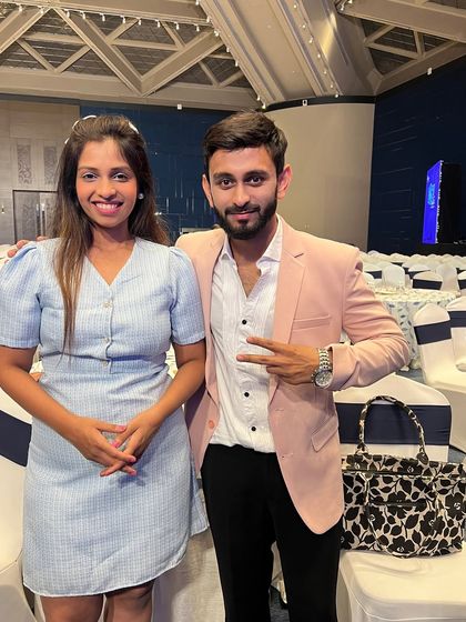 Posing with a fellow professional at a corporate conference. Building a rapport with the event team and attendees is crucial for creating a friendly and collaborative atmosphere.