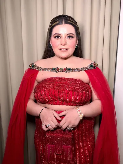 The client looks confident and beautiful in her red sequin outfit and flawless makeup.