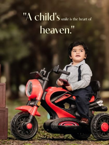 A child's smile is the heart of heaven. This little boy looks so proud on his toy motorcycle during his outdoor first birthday shoot.