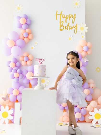 Five is a vibe! This shot perfectly captures the pride and happiness of turning five. The themed setup makes the milestone feel extra special and celebratory.