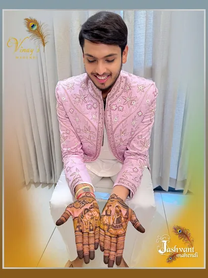 A smiling groom proudly displays his intricate henna. The design includes detailed figures and traditional patterns, showing that bold mehndi is for everyone.