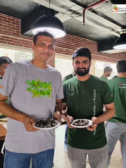 Two employees from Amdocs/Nxtra showing their handmade seed balls. It's a simple activity with a potentially huge environmental impact.