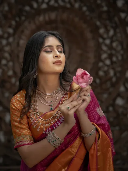A serene and artistic portrait, the model holding a lotus flower, her expression one of peaceful contemplation.