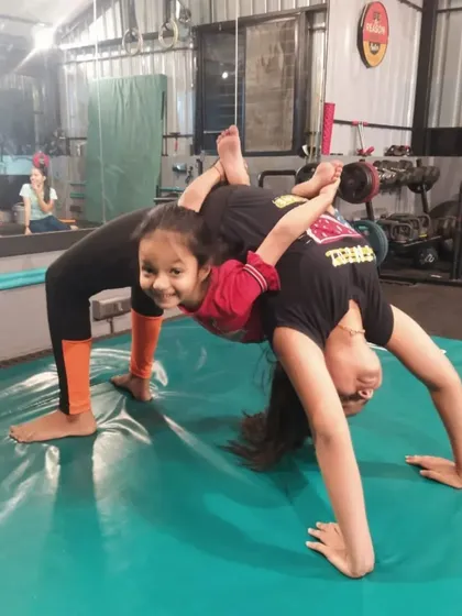 This two-person backbend pose is an excellent partner stretch that improves flexibility in the spine and shoulders while building trust.
