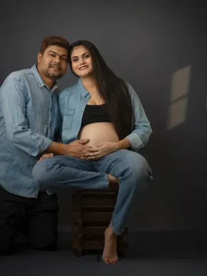 A modern couple's maternity portrait in matching denim. This casual and cool style is perfect for couples who want a relaxed and contemporary feel.