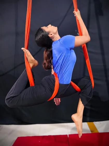 Aerial yoga is not just about flexibility, it's about finding balance and poise while suspended in air. This beautiful pose on the aerial hammock shows the artistry and control our adult students develop in their practice.