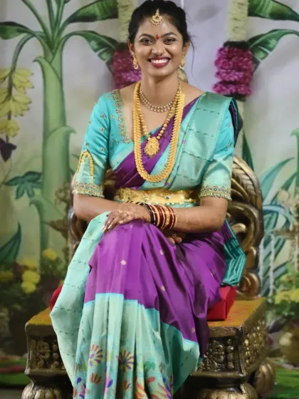 Nothing makes me happier than a smiling client. This is a complete traditional look for a family function, with makeup and hair styled to perfectly match her beautiful turquoise and purple silk saree.