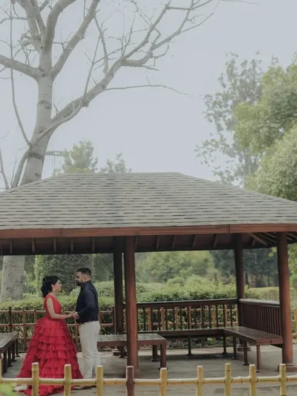 A wide shot capturing the serene atmosphere of a garden gazebo in Pune. This image showcases how I use the environment to frame a couple, creating a sense of privacy and romance in a grander setting.