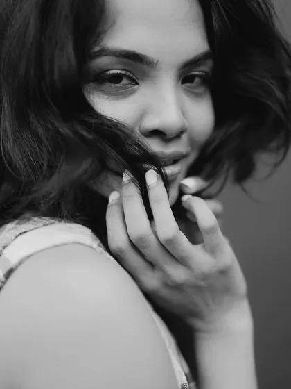 A close-up black and white portrait. I focused on creating flawless skin and defining the eyes with a soft liner to draw attention to the model's direct gaze.