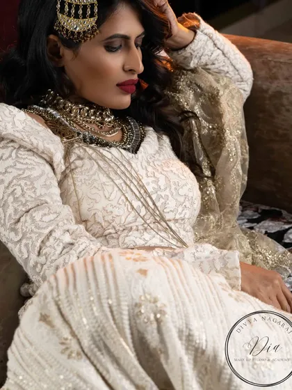 Glamour and confidence. This editorial look features a bold red lip, smoky eyes, and layers of statement jewellery for a high-fashion, powerful aesthetic.