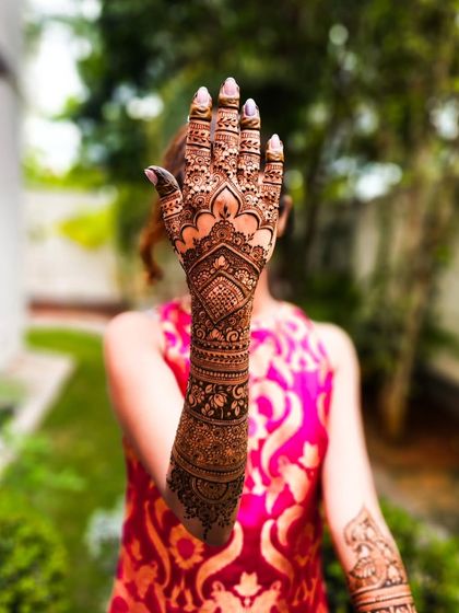 The back of the hand, featuring a classic design with a central motif and detailed fingers.