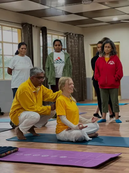 Personal guidance is key to a safe and deep practice. Here, I am helping a student find a steady and comfortable posture for pranayama, ensuring the spine is erect for the optimal flow of prana, or life-force energy.