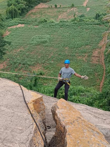 A climber confidently controls his descent during a rappelling session in Ramanagara.