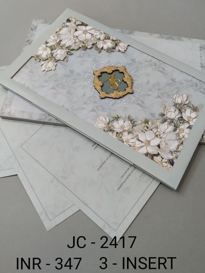 A beautiful framed invitation with 3D white flowers on a soft sage green background. This three-insert set is delicate and fresh, ideal for a spring or garden wedding.