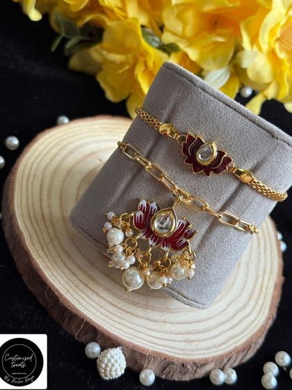 A beautiful lotus-themed Lumba and Rakhi set. The intricate enamel work and delicate pearl drops make this a truly elegant choice for your bhaiya and bhabhi.