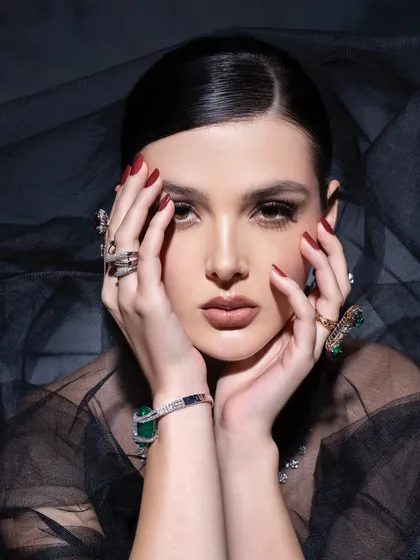 "Be like a diamond, precious and rare." This close-up beauty shot focuses on the intricate details of the rings and bracelet, paired with elegant makeup and a sheer veil to create a sense of mystery and luxury.