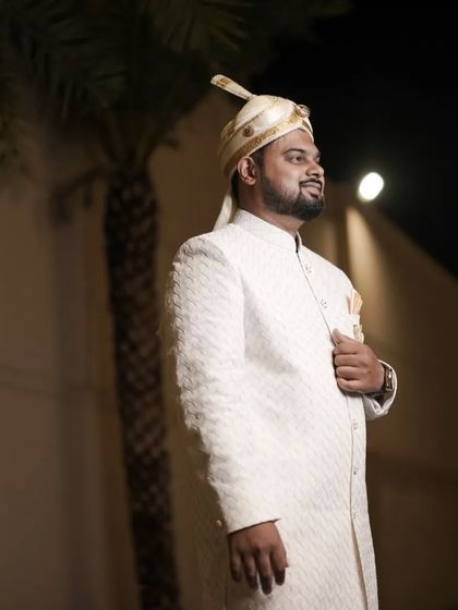 A handsome portrait of the groom in his traditional wedding sherwani, captured during his reception.