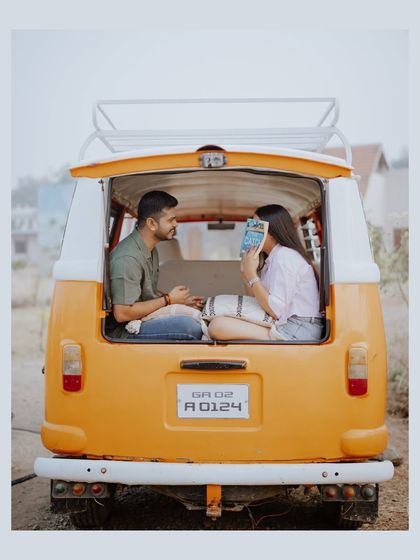 A cozy shot from the back of the van, capturing the couple sharing a quiet moment, perfect for a road-trip love story.