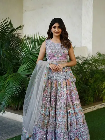 The same multi-colored pastel lehenga, showing the full outfit with its sheer dupatta.