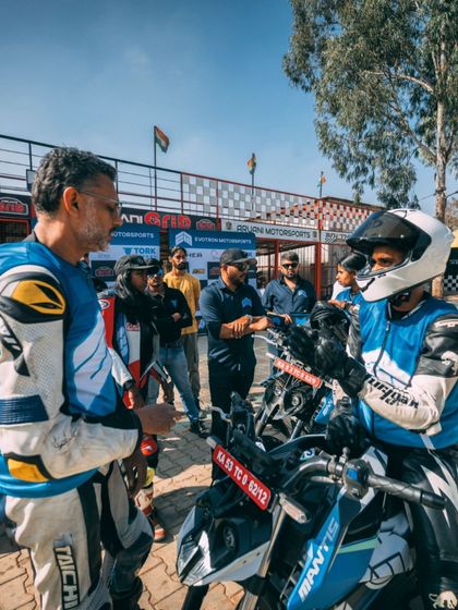 A shot of me coaching a rider on an electric motorcycle at the track. Hands-on instruction is key to building a rider's confidence and technique.