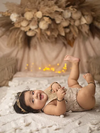 That moment you realize you're the star of the show. Her happy kicks and big smile are what these milestone sessions are all about.