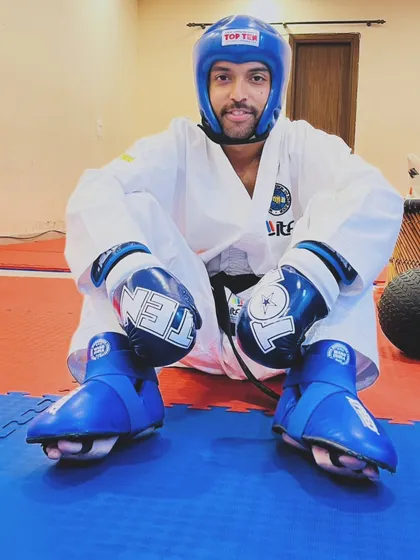 Taking a moment after a tough sparring session. I'm fully geared up here, showing the protective equipment we use to ensure safety during training.