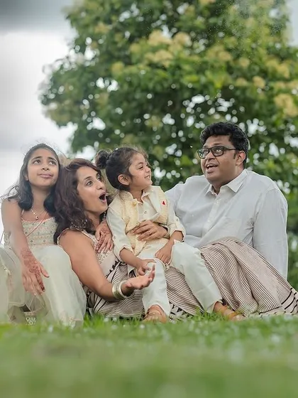 A candid, low-angle shot of a family looking up at the sky together. We love finding creative perspectives that show your family's connection and sense of wonder during an outdoor shoot.