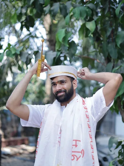 A playful shot of the groom adjusting his cap during his Haldi ceremony.