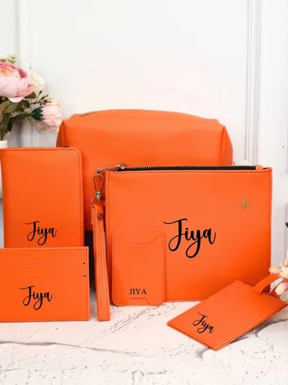 This 6-piece personalized travel set is shown in a bold orange. It's a complete solution for keeping your travel documents and essentials organized.