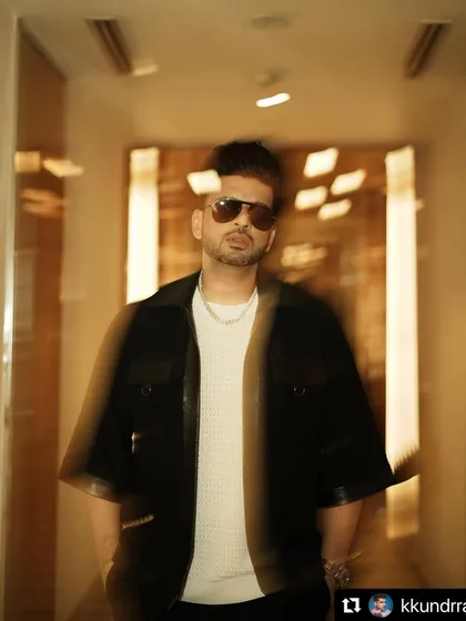 Styling Karan Kundrra in a cool, edgy look featuring a black jacket with leather details. This motion-blur shot captures the dynamic energy of the outfit.