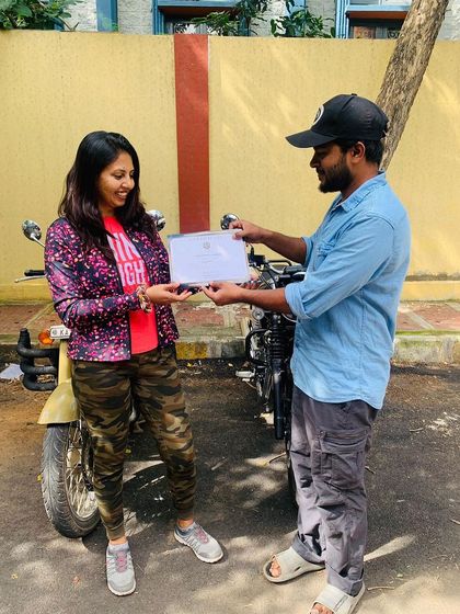 A student is awarded her certificate, officially welcoming her into the community of women motorcycle riders.