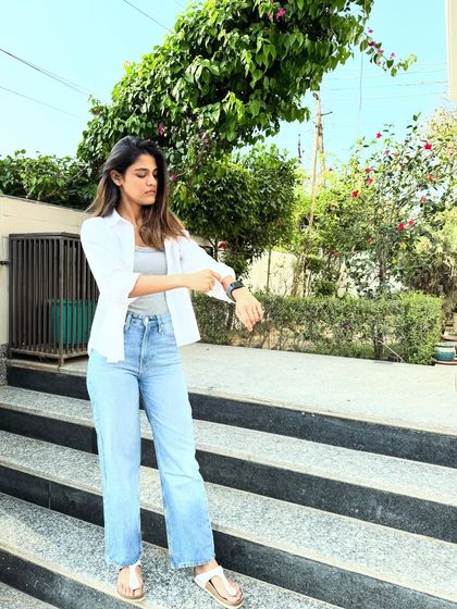 A candid moment checking the time. Even in a basic outfit, good posture and carrying yourself with confidence is the best accessory.