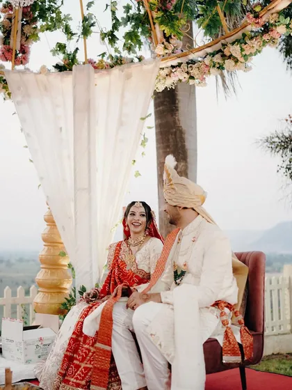 Seated together during the ceremony, this couple shares a look of love and happiness. The beautiful outdoor setting with a mountain view adds a grand scale to their intimate moment.