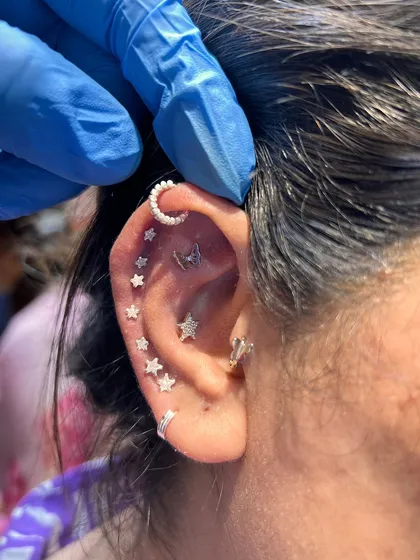 This fully curated ear is a galaxy of its own. We combined multiple star studs, a crescent moon hoop, and a butterfly stud to create a truly magical and personalized look.