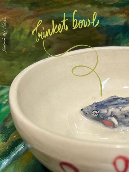 A tiny mouse finds a home in this handmade ceramic bowl. These pieces are perfect for holding everything from earrings to paper clips, adding a touch of handmade charm to any space.