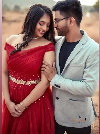 A sweet and romantic pre-wedding moment. The off-shoulder red gown with an embellished belt adds a touch of sparkle to this lovely couple's photo.