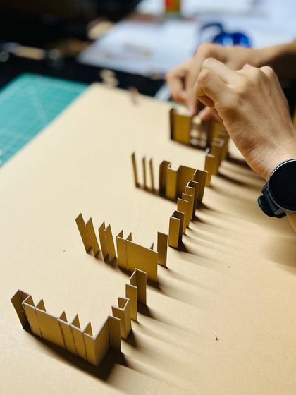 A study model being assembled in our studio. We use simple materials like cardboard to quickly create and test different wall configurations and spatial sequences, allowing for rapid design iteration.