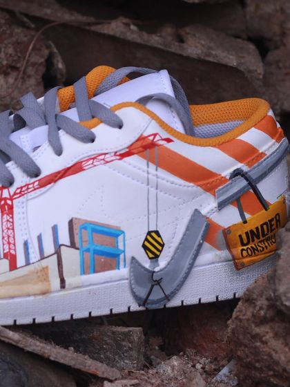 A detail shot of the construction-themed custom sneaker, where the Nike swoosh is transformed into a crane hook. It's these little details that make a custom design special.