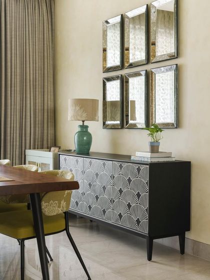 The dining area of the Ivy Nest project features an exquisite bone inlay table and a composition of weathered mirrors. These elements work together to create a chic and minimal aesthetic that is both elegant and modern.