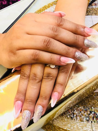 This set shows how you can mix and match styles, with some nails getting the French tip treatment and others going full glam with glitter.