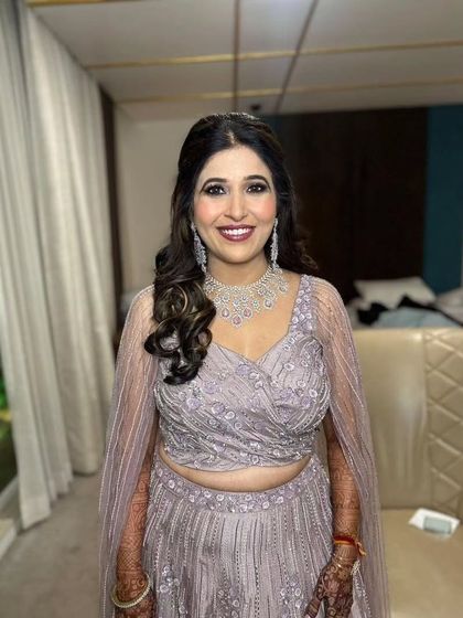 The groom's mom, looking radiant and ready for the Sangeet. I created a sophisticated glam look that enhances her features and complements her beautiful pastel outfit.