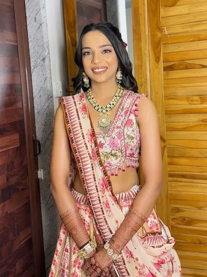 The complete look, showing how the soft makeup and hairstyle complement her beautiful floral outfit.