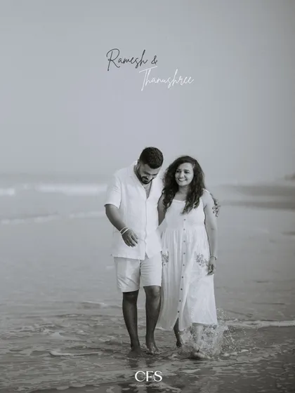 A classic black and white photo of the couple walking along the shoreline. This edit adds a timeless, nostalgic quality to their beach pre-wedding story.