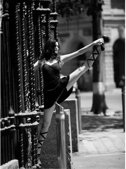 An extension pose, demonstrating the control and technique learned from classical ballet and jazz. This foundation allows for more dynamic and impressive choreography.